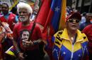 An elderly protester carries a Venezuela's flag during a march for peace in downtown Caracas