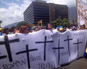 Relatives and students march with a banner naming people killed in the protests, in a mass opposition demonstration in Caracas on Saturday Feb. 22. Credit: Estrella Gutiérrez/IPS