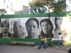 Faces of mothers whose children were killed in criminal violence peer out from walls in Caracas. Venezuela has one of the highest murder rates in the world. Credit: Fidel Márquez /IPS