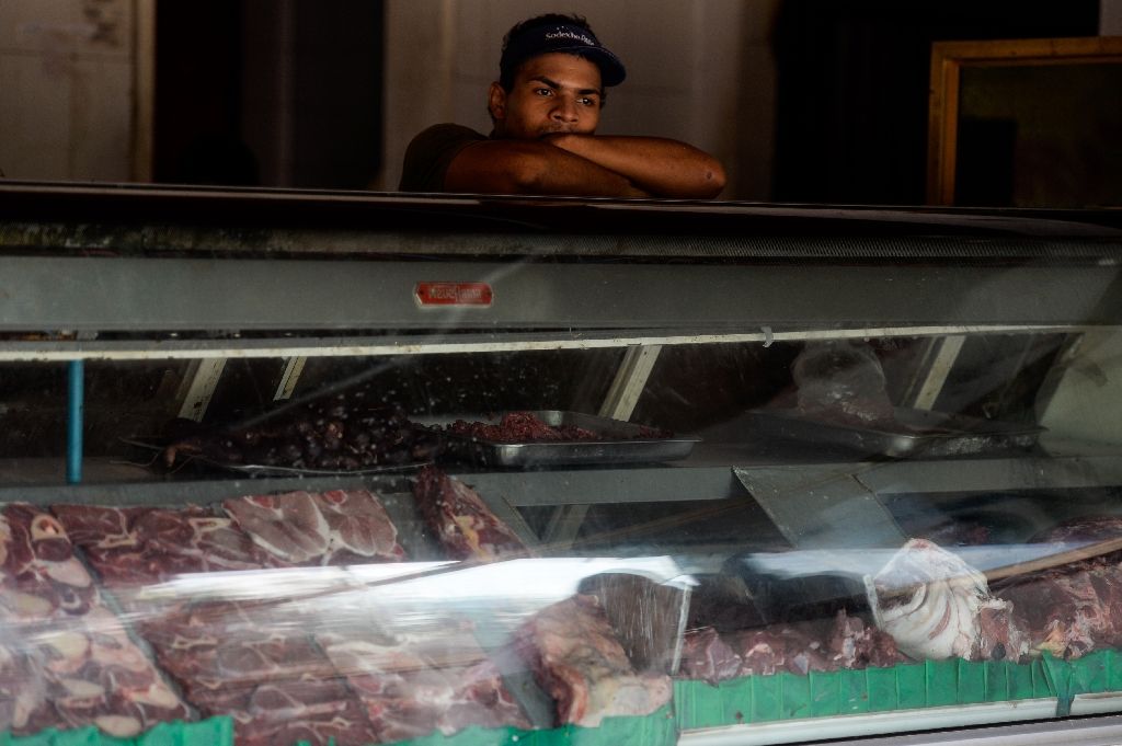An employee of a butcher shop waits during a power cut in Santa Teresa, Venezuela on April 25, 2016 An employee of a butcher shop waits during a power cut in Santa Teresa, Venezuela on April 25, 2016 (AFP Photo/Federico Parra)