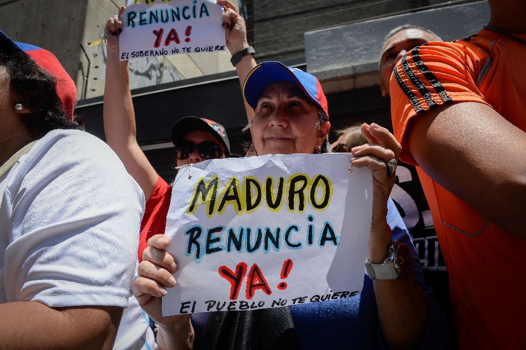 Opponents of the Venezuelan government shout slogans during a demonstration demanding the resignation of President Nicolas Maduro in Caracas. (AFP Photo/Federico Parra)