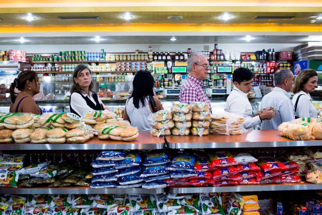 Store shelves that are well-stocked, like those in this bakery near Zerpa’s house, are typically full of non-essential items set at sky-high prices.